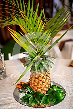 Pineapple decoration with palm leaves