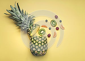 Pineapple with different fruits, oranges, kiwis, grapes and blueberries