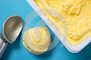 pineapple flavor ice cream and scooped and a ball at horizontal composition