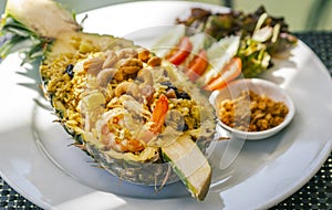 Pineapple fried rice with shrimps, Thai food popular menu of fried rice, beautiful food decoration, serve fried rice in half fresh