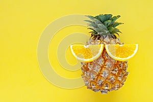 Pineapple fruit with slice oranges set as the eyes