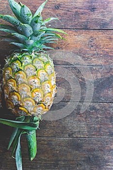 Pineapple fruit on wood table