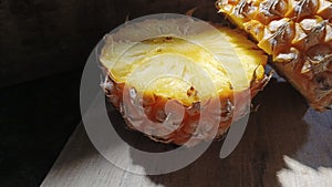 Pineapple and its shadow on the cement floor.