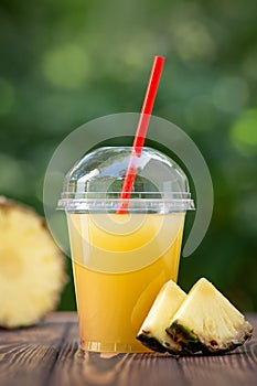 Pineapple juice in disposable plastic cup