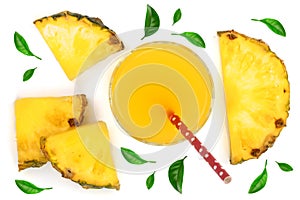 Pineapple juice in a glass with pineapple slices decorated with green leaves isolated on white background. Top view