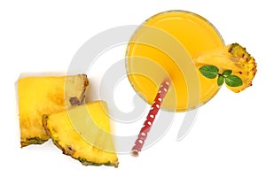 Pineapple juice in a glass with pineapple slices isolated on white background. Top view