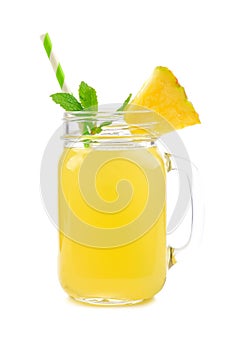 Pineapple juice in a mason jar glass isolated on white