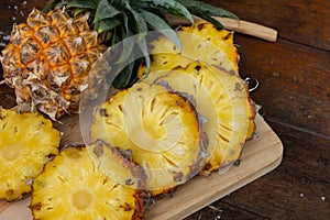 Pineapple juice and piece of fruits ready to eat on the wood tab