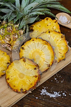 Pineapple juice and piece of fruits ready to eat on the wood table