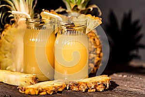 Pineapple juice and slice placed on a wooden table