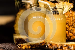 Pineapple juice and slice placed on a wooden table