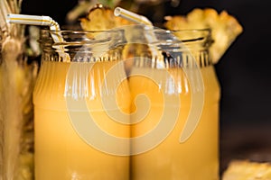 Pineapple juice and slice placed on a wooden table