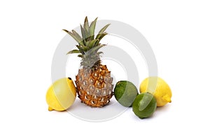 Pineapple with lemon and lime on a white background. Green lime, pineapple close-up and yellow lemon on an isolated white backgrou