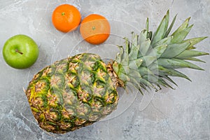 Pineapple, mandarines and apple