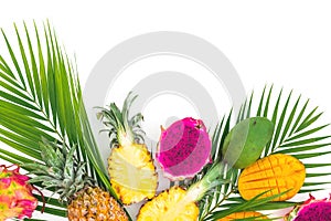 Pineapple, mango and dragon fruits with palm leaf on white background. Flat lay, top view. Tropical fruits