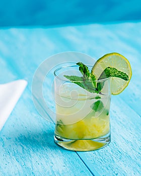 Pineapple mojito cocktail on a bright blue background