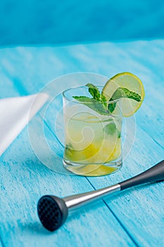 Pineapple mojito cocktail on a bright blue background