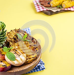 Pineapple and peach barbecued grilled picnic. Free space for text. Summer Lunch. Copy space. flat aly