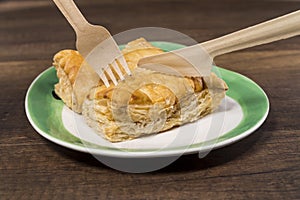 Pineapple pie on white plate with fork and knife