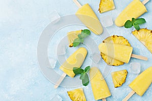 Pineapple popsicles or homemade ice cream top view. Summer refreshing food. Frozen fruit pulp.