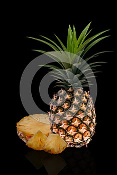 Pineapple set. Whole pineapple and slices isolated on black background.
