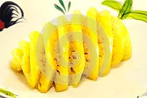 Pineapple slice on a plate placed on dish isolated on a white background that can be easily used to make illustrations or designs.