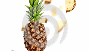 Pineapple slices and leaves in motion.