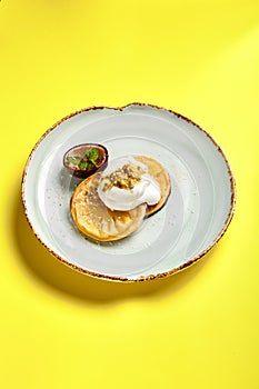 Pineapple slices with maracuya sauce top view