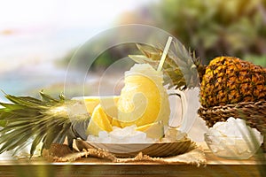 Pineapple slush on wooden table with nature background