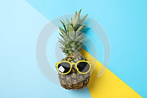 Pineapple with sunglasses on three tone background