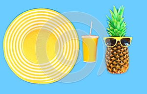 Pineapple with sunglasses and yellow straw beach hat cup juice on blue background
