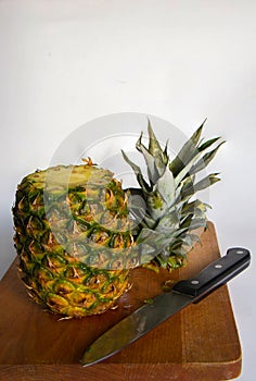 Pineapple on the wooden plate