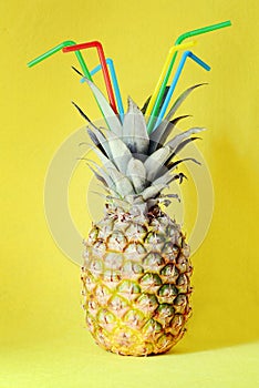 Pineapple on a yellow background. Beach and tropical. Cocktail party