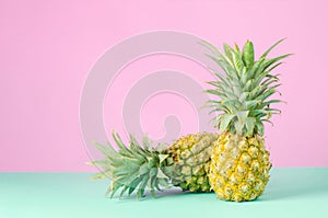 Pineapples on blue and pink pastel background - Summer background