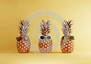 Pineapples gang in summer costumes style on yellow background. Fruits and holiday vacation concept. 3D illustration rendering