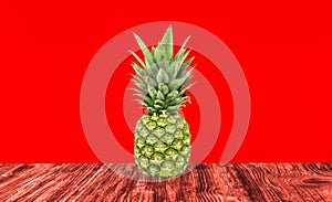 Pineapples on a red wooden background