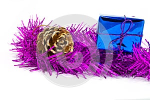 Pinecone and gift box on tinsel