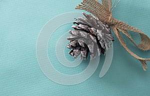 Pinecones Christmas ornament on blue wrapping paper