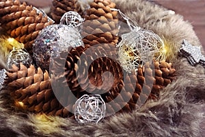 Pinecones, christmas ornaments and garland in fur hat