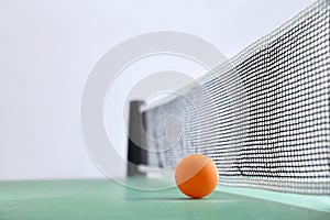 Ping-pong background with ball on green table and white background