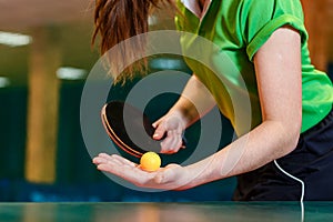 ping pong paddle and ball in female hands close. Serve the ball in table tennis