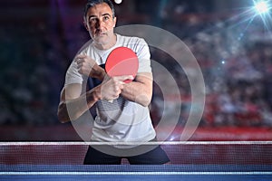 Ping-pong player receiving a ball in a exhibition with stands