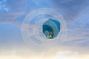 Bright blue paper Lantern flying in the sky photo