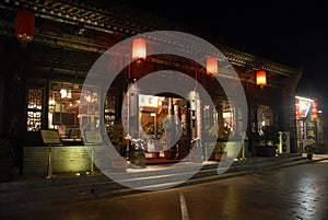 Pingyao in Shanxi Province, China: Street in Pingyao at night with a traditional restaurant and red lanterns