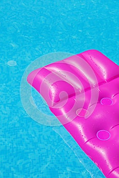 Pink air mattress on a swimming pool. holiday tropical concept