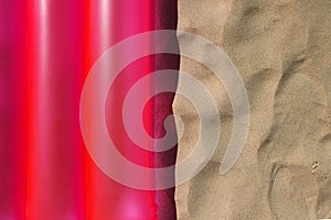 Pink air pool mattress and sand texture, close up and top view