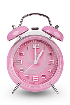 Pink alarm clock with hands at 1 am or pm isolated on white background