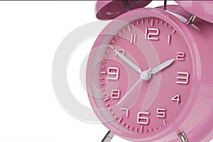 Pink alarm clock with the hands at 10 and 2 am or pm isolated on a white background
