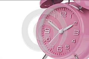 Pink alarm clock with the hands at 10 and 2 am or pm isolated on a white background photo