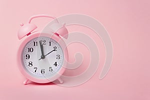 Pink alarm clock on pink background top view Flat lay copy space. Minimalistic background, concept of time, deadline, time to work